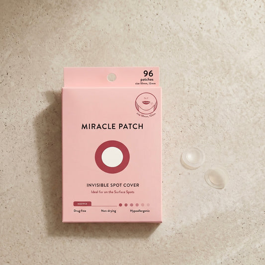 Pink packaging of Miracle Patch on a beige surface